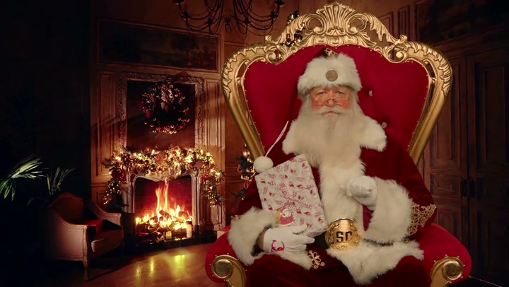 The app’s Santa in his red suit, seated in an ornate red chair during a video call